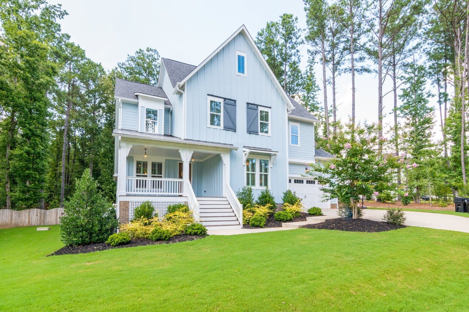 blue house on green lawn Choosing the Perfect Rental Property