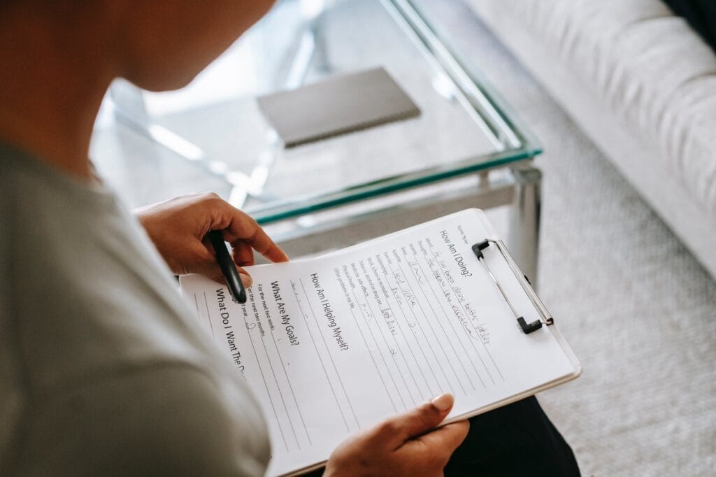 crop woman reading notes on clipboard tenancy issues