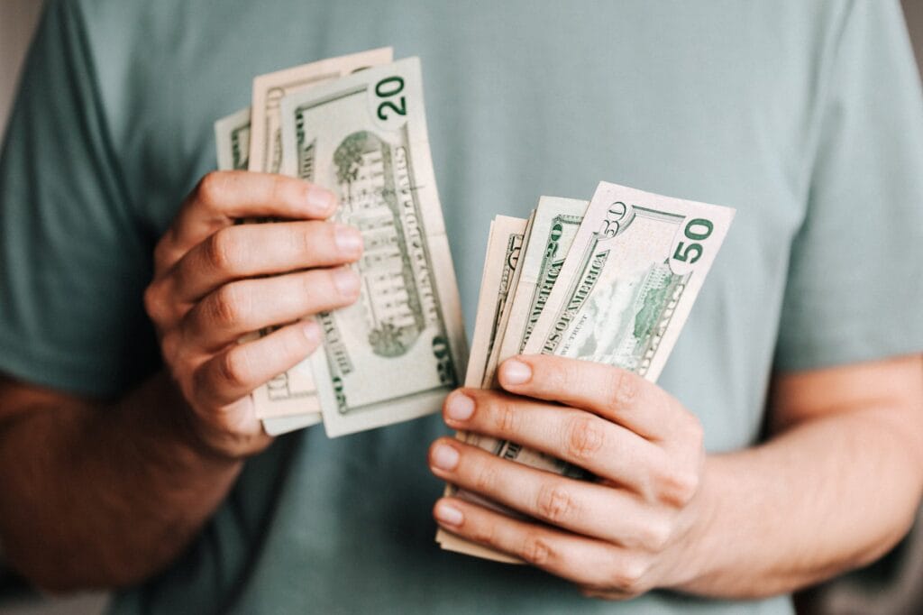 crop man counting dollar banknotes How to Fund Your College Education with Real Estate Investing: A Practical Guide