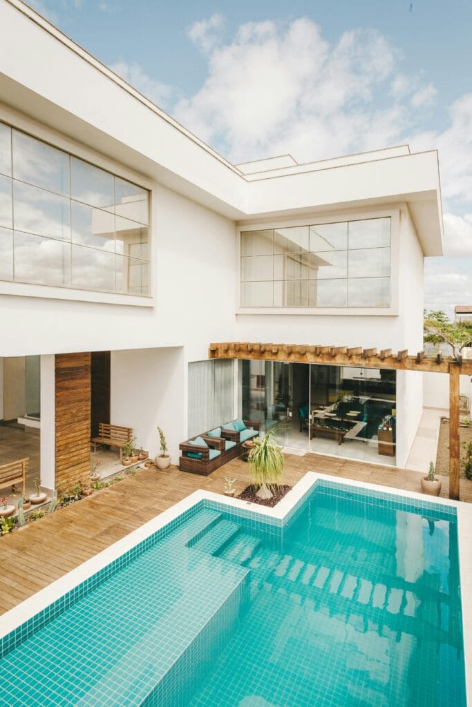 pexels-photo-5563472-5563472 Contemporary interior of lounge area with swimming pool located on terrace of luxury villa in sunny day